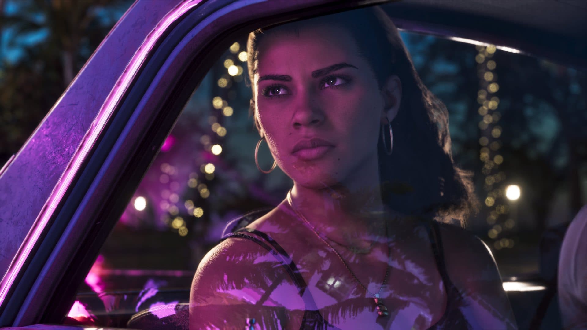 Lucia lit by neon in a car at night