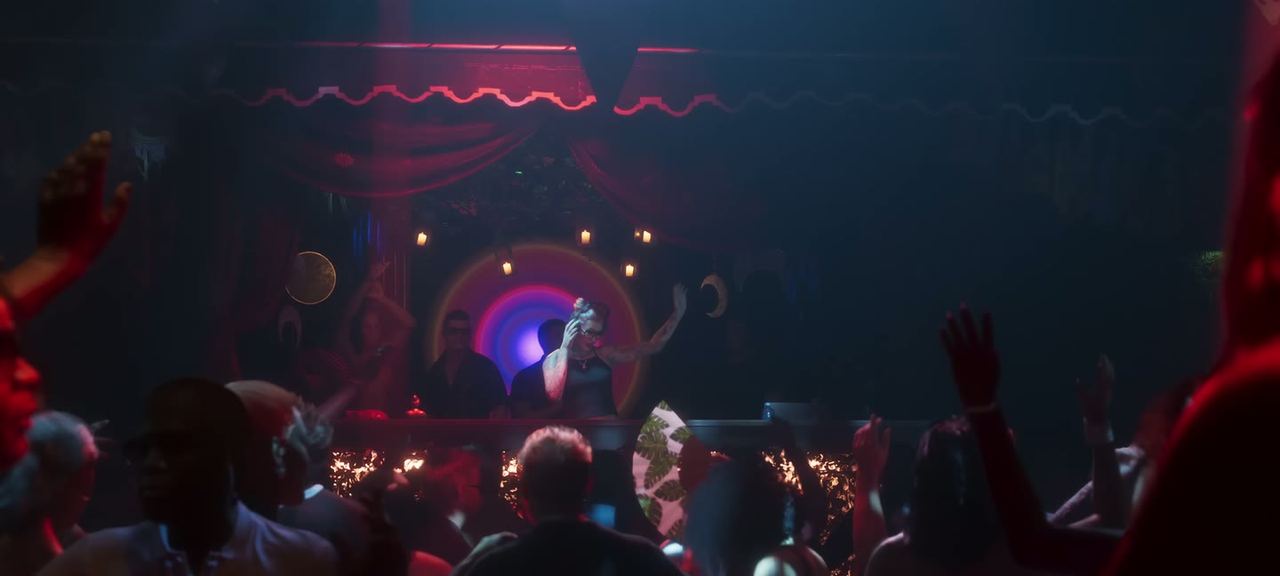 A stage act under red light.