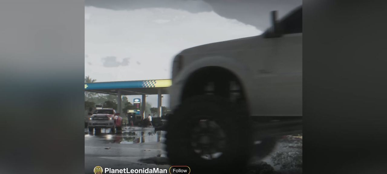A white dually pick-up pulling out of a gas station, shot as a social post.