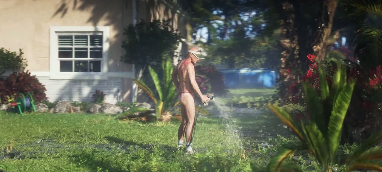 A sprinkler on a suburban lawn, somebody walking through it.