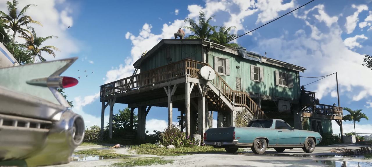 Brian Heder's stilt house in the Keys, with a teal Vapid coupe utility parked under it and the tail fin of a fifties classic in the foreground.
