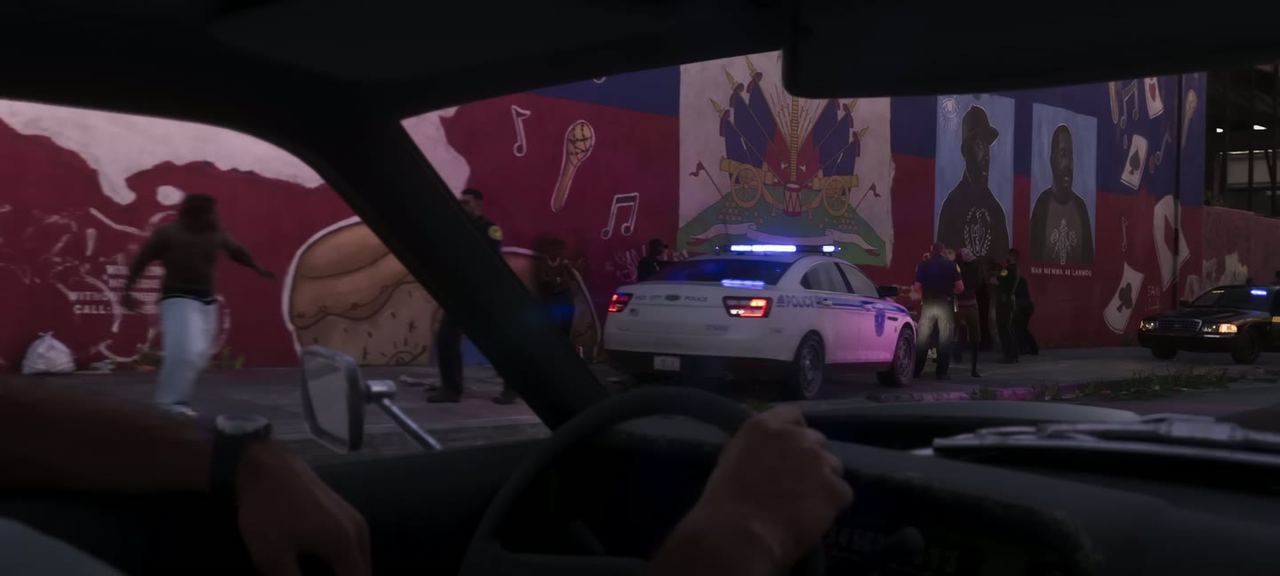 Interior of a car with police lights in the mirror.