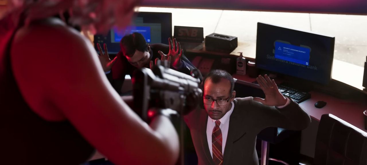 An armed robbery in progress, a man raising his hands behind a desk.