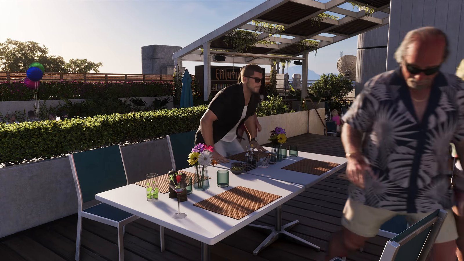 Two men at a rooftop bar in Vice City, one leaning over a table of drinks