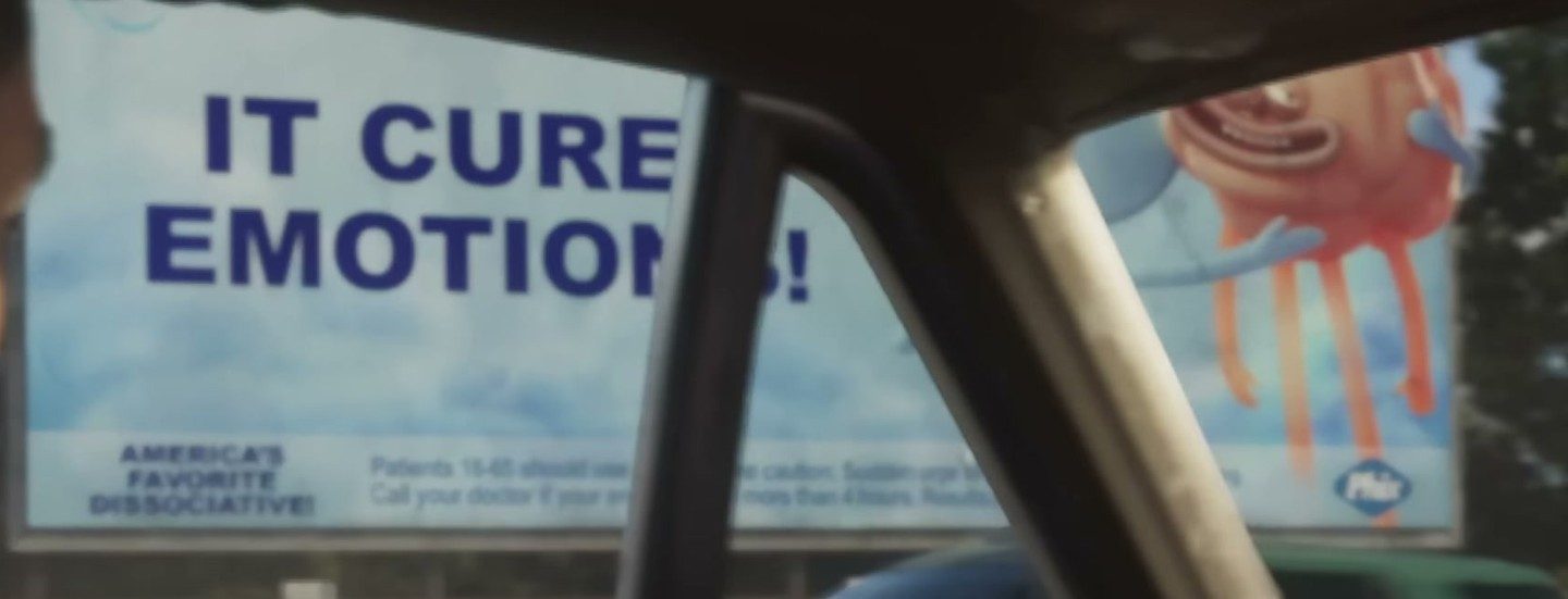 A billboard reading IT CURE EMOTIONS and America's favorite dissociative, seen through a car windscreen
